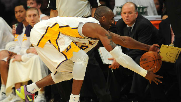 Kobe Bryant reaches for a basketball.